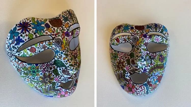 A finished mask covered in hand-drawn flowers, from Mask Decorating