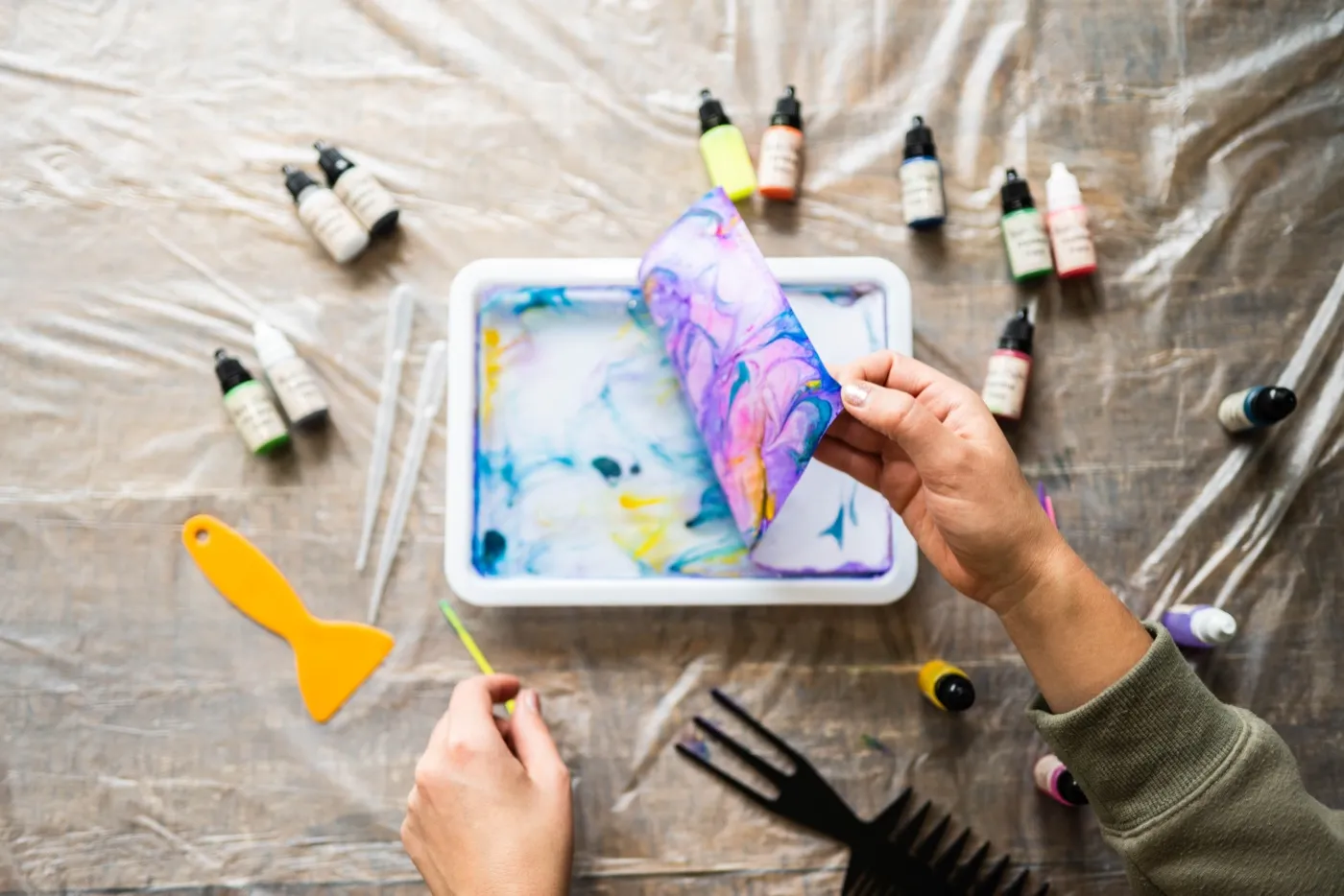 Lifting a marbled print off the water